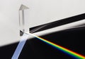 A prism dispersing sunlight splitting into a spectrum on a white background. Royalty Free Stock Photo