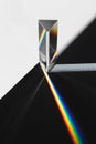 A prism dispersing sunlight splitting into a spectrum on a white background. Royalty Free Stock Photo