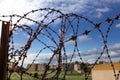 Prison. Barbed wire. Barbed wire on blue sky background with white clouds. Wire boom. Military conflict . Syria. Royalty Free Stock Photo