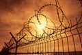 Prison barbed wire fence at sunset Royalty Free Stock Photo