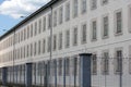 Prison building with razor wire fence Royalty Free Stock Photo