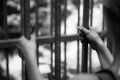 Prison cell: Close up of hands in jail