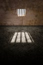 Prison cell, inside a prison cell. Window of a penitentiary. Shadows projected on the ground. Prison sentence, window bars.