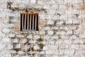 Prison cell window with wooden bars in a white brick wall Royalty Free Stock Photo