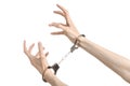 Prison and convicted topic: man hands with handcuffs isolated on white background in studio, put handcuffs on killer Royalty Free Stock Photo