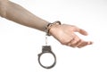 Prison and convicted topic: man hands with handcuffs isolated on white background in studio, put handcuffs on killer Royalty Free Stock Photo