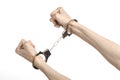 Prison and convicted topic: man hands with handcuffs isolated on white background in studio, put handcuffs on killer Royalty Free Stock Photo