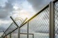 Prison security fence. Barbed wire security fence. Razor wire jail fence. Barrier border. Boundary security wall. Prison for