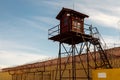 Prison tower and barbed wire fence