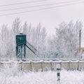 Prison tower at the fence with barbed wire. in winter in snow