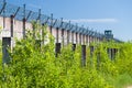 Prison wall and sharp wire barbs coiled Royalty Free Stock Photo