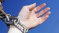 A woman`s hand in a thick chain