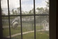 Prison yard with razor wire, guard house and satellite dishes Royalty Free Stock Photo