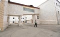 Prison yard, windows, bars of Lukyanovskaya detention facility and guard standing