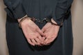 Close-up. Arrested woman handcuffed hands at the back isolated on gray background Royalty Free Stock Photo