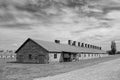 Prisoner barracks in Auschwitz Birkenau concentration camp under a cloudy sky, Poland Royalty Free Stock Photo