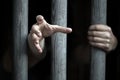 Prisoner behind wooden bars begging for help Royalty Free Stock Photo