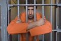 Prisoner Standing Behind Bars Royalty Free Stock Photo