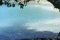Pristine beach framed by a tree in a tropical island Royalty Free Stock Photo