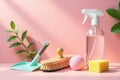 A pristine cleaning setup with a dustpan, brush, spray bottle, and sponge, arranged on a soft pink surface, bathed in sunlight, Royalty Free Stock Photo