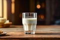 a pristine glass of milk on a charming wooden table.