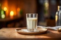 a pristine glass of milk on a charming wooden table.