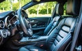 A pristine interior view of a modern vehicle showcases black leather seats with detailed stitching. Sleek design of the