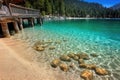 Pristine lake tahoe shoreline with crystal clear waters and pine forest Royalty Free Stock Photo