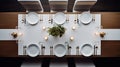 a pristine marble dining table, featuring neatly arranged white ceramic plates on stands, gleaming silverware, condiment