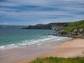 The pristine sand of Whiterocks Beach and coastal cliffs on the Antrim Causeway Coast in Northern Ireland, UK Royalty Free Stock Photo