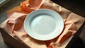 A pristine white dinner plate rests gently on a soft, peach-colored tissue paper nestled within a simple cardboard box, a study in Royalty Free Stock Photo