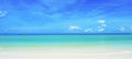 Pristine white sand beach, sea & blue sky meeting in horizon Royalty Free Stock Photo