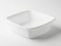 A pristine white square plastic container with a lid resting on a plain surface isolated on white background Royalty Free Stock Photo