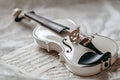 Elegant White Violin Resting on Sheet Music with Bow Royalty Free Stock Photo