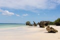 Pristine white tropical beach with rocks, blue sea and lush vegetation on the African Island of Misali, Pemba, Zanzibar.