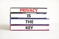 Privacy is the key symbol. Concept words Privacy is the key on books on a beautiful white table white background. Business, Royalty Free Stock Photo