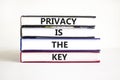 Privacy is the key symbol. Concept words Privacy is the key on books on a beautiful white table white background. Business, Royalty Free Stock Photo