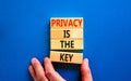 Privacy is the key symbol. Concept words Privacy is the key on wooden blocks on a beautiful blue table blue background. Royalty Free Stock Photo