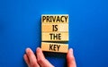 Privacy is the key symbol. Concept words Privacy is the key on wooden blocks on a beautiful blue table blue background. Royalty Free Stock Photo