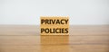 Privacy policies symbol. Concept words `Privacy policies` on wooden blocks on a wooden table. Beautiful white background. Busine