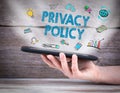 Privacy policy. Tablet computer in the hand. Old wooden background Royalty Free Stock Photo