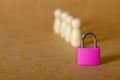Privacy and Protection Concept: Small Padlock in Front of Anonymous Wooden Figures Royalty Free Stock Photo
