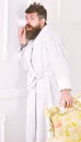 Privacy and secret concept. Man with beard and mustache eavesdrops using cup near wall. Hipster in bathrobe on surprised Royalty Free Stock Photo