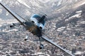 Privat plane or aircraft flight above winter resort city, village surrounded by mountains