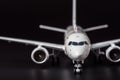 Private Airplane model on black background. Front view of passenger or cargo aircraft, business jet, airline