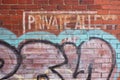 Private Alley sign with graffiti.