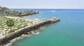 Private beach club in the district of Chorillos with distant shore covered in air pollution haze in Lima. Royalty Free Stock Photo