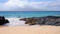 Private beach with sand and lava rocks in Maui Hawaii Royalty Free Stock Photo