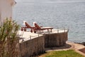 Private beaches on mediterranean sea. Chairs, deck chairs, sun loungers and parasols waiting for tourists.