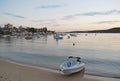 Private boat on the beach at Manly Cove during pink sunset in Sydney Royalty Free Stock Photo